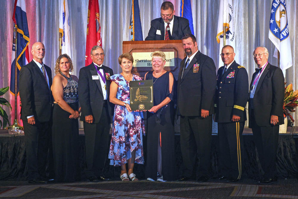 FOR ONE’S COUNTRY
Missouri State University was honored by the U.S. Department of Defense for extraordinary support of employees who serve in the National Guard and reserves. Receiving the Pro Patria award on behalf of the school is Raeleen Ziegler, director of MSU’s Veteran Student Center, fourth from right. At an Aug. 9 ceremony in St. Louis, she is joined by fellow MSU staff members, Paul Ziegler, her husband, to her right, and Nancy Gordon, fourth from left, as well as program officials with Employer Support of the Guard and Reserve.